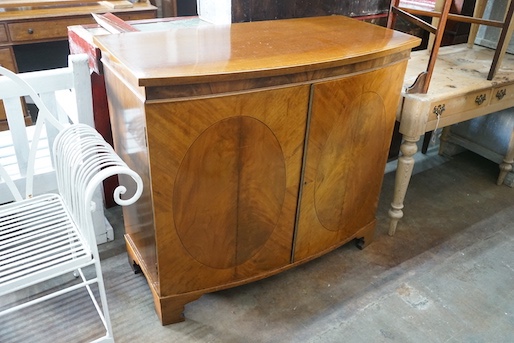 An Edwardian Sheraton revival satinwood banded mahogany bowfront two door side cabinet, width 106cm, depth 53cm, height 95cm